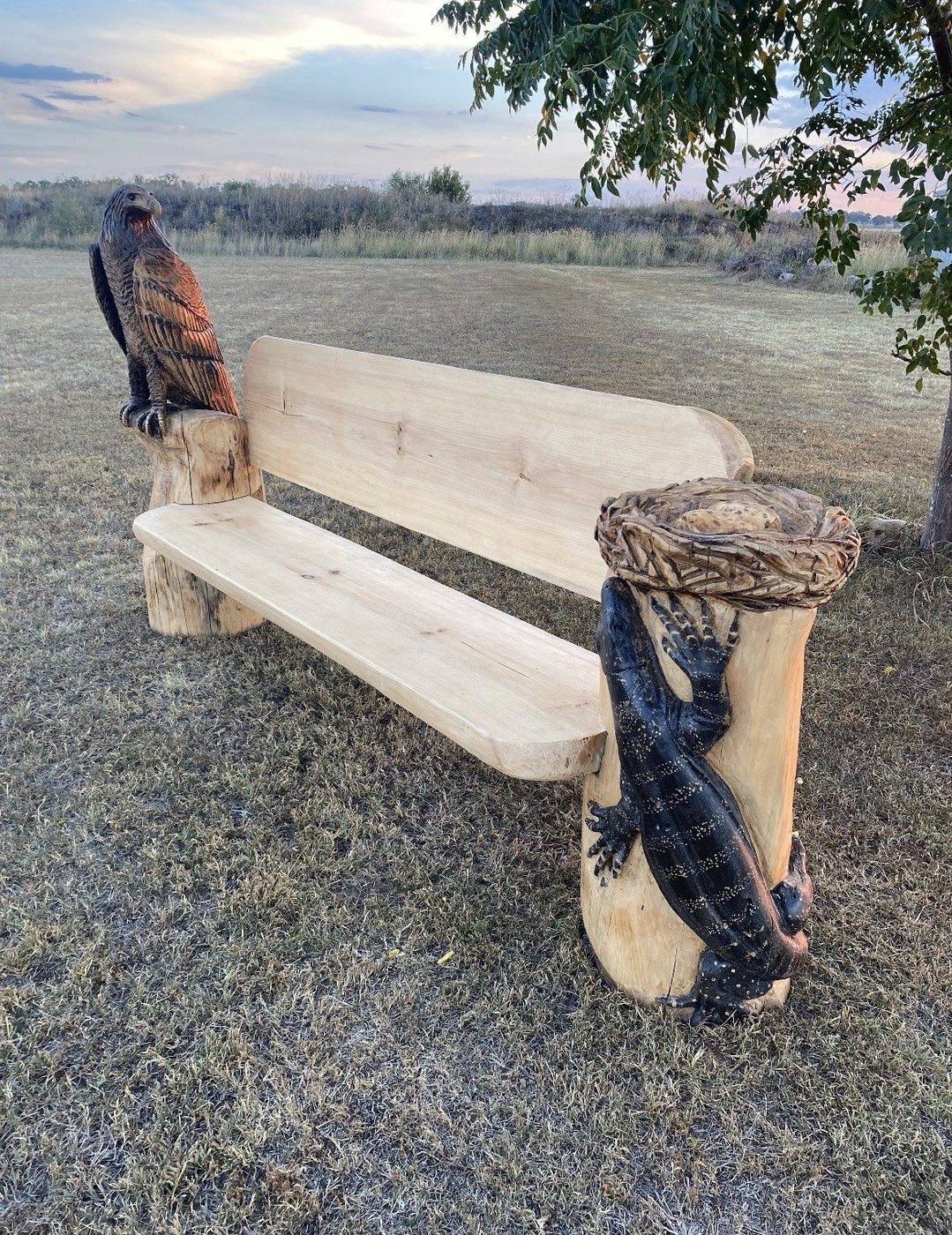 Carved timber bench with eagle and goanna by Cossy's Chainsaw Artistry