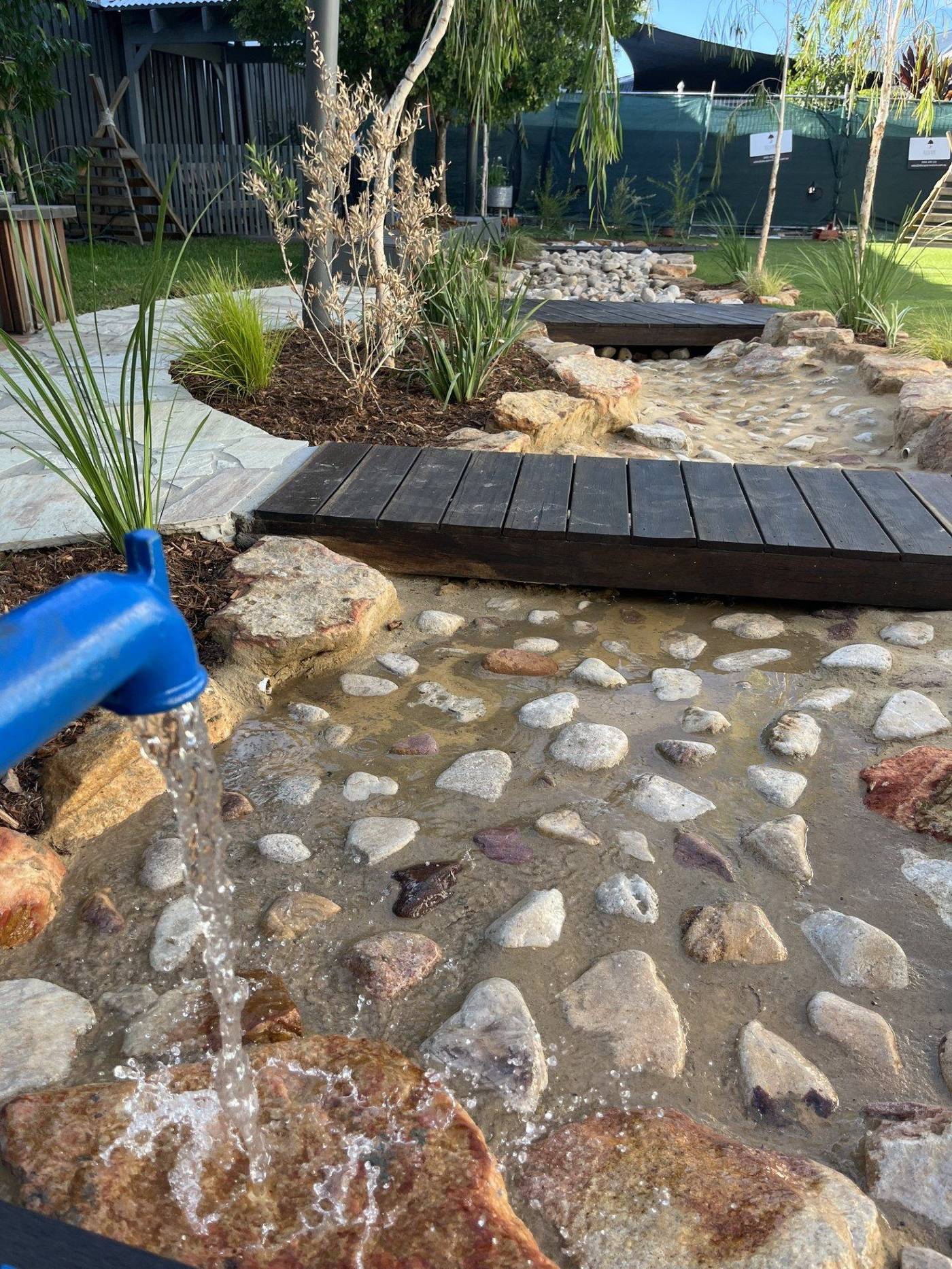 Completed playground area with soft surfacing and play structures