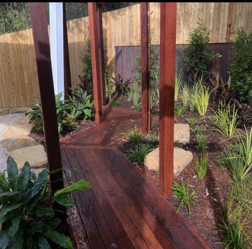 Hardwood timber boardwalk with sandstone stepping stones and native plantings
